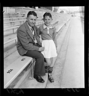 Mr B S Sadler and son Bobby in rugby uniform at Athletic Park, Wellington