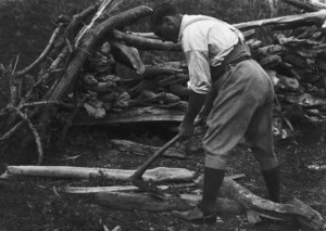 Teko Chadwick using a traditional Maori adze