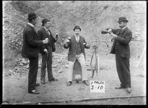 Men drinking a toast, and bicycle