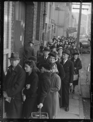 Group queuing for rationed goods during World War 2, outside Salisbury's on Dixon Street, Wellington