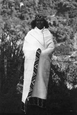 Rangi Pokiha's mother modeling a fine flax cloak with taniko boarders, at Koriniti