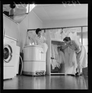 Two unidentified women drying and airing undergarments, at a Lower Hutt factory, Wellington