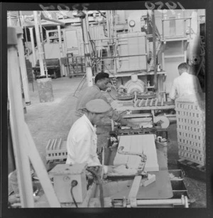 Unidentified men processing [soap?] products, at a Lower Hutt factory, Wellington