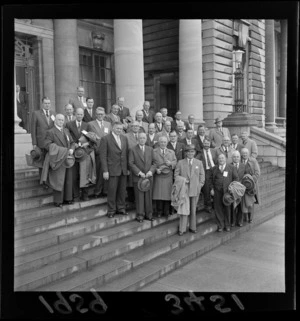 Large group of unidentified men [Labour Delegation?], including a young Norman Kirk, on a deputation to Labour Prime Minister Walter Nash, Parliament Steps, Wellington City