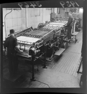 The Miehle Printing Press on which the Agricultural Journal was printed being operated by two unidentified workmen, [Evening Post Building?], Wellington City