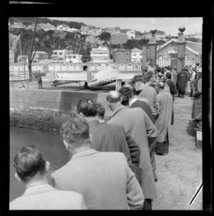 Crowd of unidentified people viewing Vampire Jet NZ5751 at Clyde Quay wharf, Wellington.