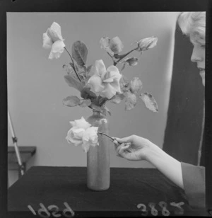 Roses in a vase and unidentified woman