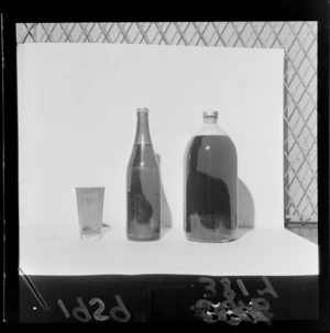 Display of bottles of beer and a glass, largest is half gallon bottle