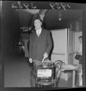 Mr F G Kitts, dropping his voting papers into box, at the Town Hall polling booth, Wellington, during [mayoral ?] elections