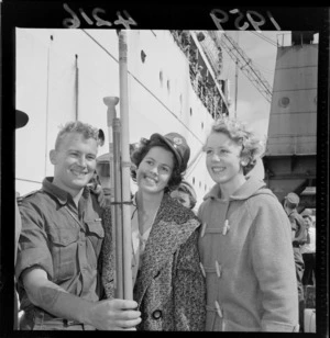 Private Mike Sextus with his sisters, Cushla and Chloe, Glasgow Wharf, Wellington, on the return of the New Zealand Army from Malaya