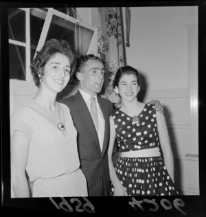 Ballet dancers at a Christmas party showing two unidentified women and a man at an unknown indoor location, Wellington Region