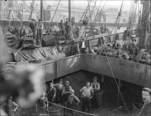 Coal workers on board an unidentified ship