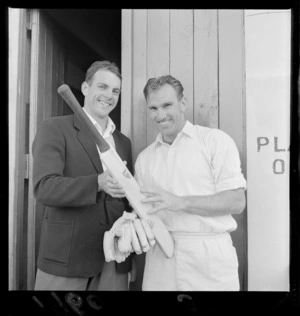Cricketers at the Basin Reserve with two unidentified men holding a cricket bat ready to play, Wellington City