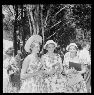 Personalities at the Tauherenikau Racecourse with three unidentified women dressed for the occasion, Wairarapa District