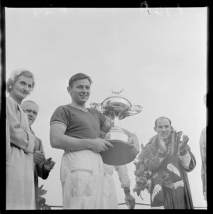 Bruce McLaren with Race Champion's Cup and Stirling Moss, Ardmore Aerodrome Racetrack, South Auckland