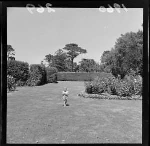 Child in the garden at Riddiford Estate, Woburn, Lower Hutt