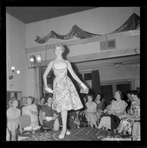 New seasons fashion show at the Skyline Restaurant with an unidentified female model on the catwalk with people looking on, Wellington City