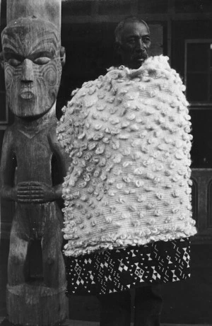 Pokiha modeling a fine flax cloak decorated with taniko, at Koroniti