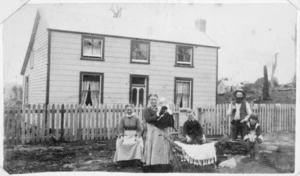 Miss A S Stenberg and Anderson family by a house in Ormond Street, Woodville, Tararua district