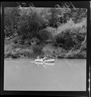 Unidentified man and boys in a rubber dinghy on Whanganui River