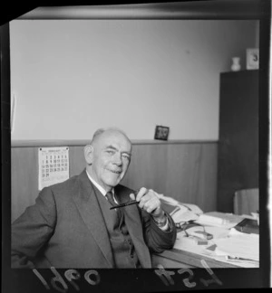 Portrait of Mr Guy K Hansard, holding a pipe, probably Wellington Region