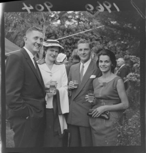 Garden party at Homewood with two unidentified couples in front of trees, Karori, Wellington