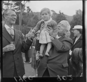Garden party at Homewood, Prime Minister Walter Nash with a young girl and an unidentified older man, Karori, Wellington