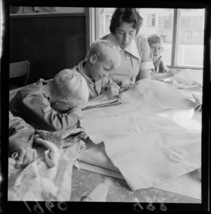 Levin Training Farm for handicapped children with unidentified teacher and children sewing within a classroom, North Wellington Region