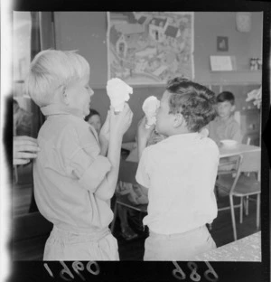 Levin Training Farm for handicapped children with two unidentified children eating ice-creams in cones within a classroom, North Wellington Region