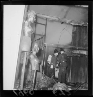 Fire damage to a department store building on Wakefield Street with two unidentified firemen with breathing tank and hose, Wellington City