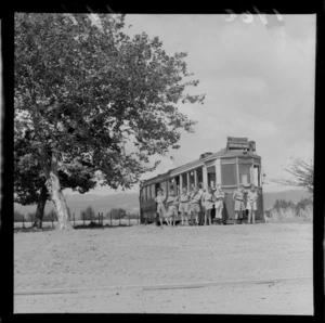 Levin Training Farm for handicapped children with unidentified boys in front of an old Wellington Oriental Bay tram by a tree, North Wellington Region