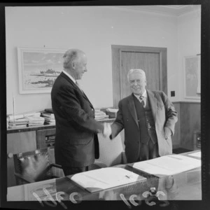 Sir Walter Nash (Prime Minister) shaking hands with American Ambassador Mr F H Russell, after signing an agreement