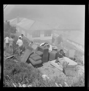 Residents moving house furniture onto hillside for protection from fire, at Island Bay, Wellington