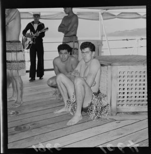 Unidentified men from a Kapa Haka performing group, wearing piupiu, on the HMNZS (Her Majesty's New Zealand Ship) 'Royalist'