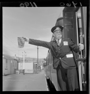 Guard signals to leave Taihape railway station on the record breaking train, that took 11 1/2 hours to travel from Wellington to Auckland 16-18 Feb 1960