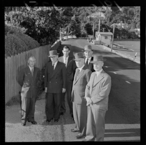 Mr Mathison, with other unidentified men, discussing traffic problems at Lowry Bay, Eastbourne, Wellington Region