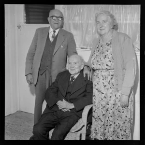 Portrait of Mr Edward Hughes on his 101st birthday with his [son and daughter?] within a unknown building location, probably Wellington Region