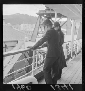 Unidentified policemen watch ships for convicted murder and escapee Angelo La Mattina from the deck of an unknown ship, Lambton Harbour, Wellington City