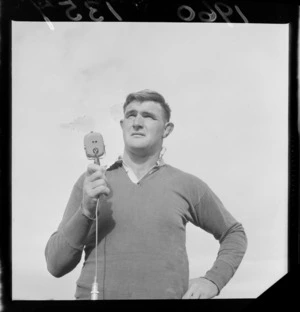 All Black No.8 Peter Jones in rugby gear standing on Athletic Park Rugby Grounds with a microphone, Wellington City