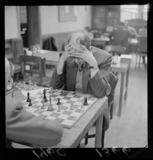 Chess Champs with an unidentified older man contemplating a move, probably Wellington Region