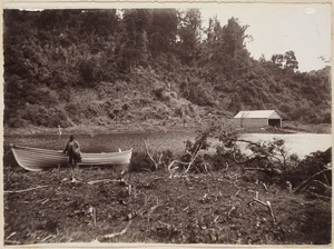 Scene on the shore of Lake Waikeremoana, Hawke's Bay, with row boat and boat shed