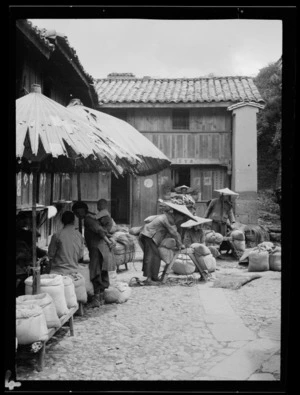 Yunnan, China. Muleteers at Tengyueh on market day. August 1938.