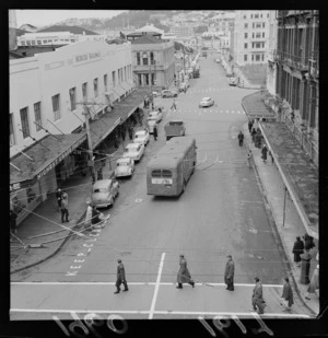 Mercer Street, Wellington, showing pedestrians, motorcars and a bus, including Mercer buildings and other shops