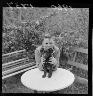 An unidentified boy with a dog, at Blue Cross Kennels