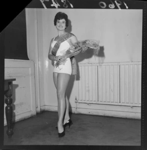 Miss Loraine Jones 'Miss Wellington' with winner's sash and a bouquet of flowers, Wellington City Town Hall