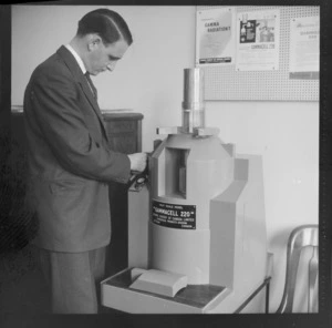 Cobalt machines at the Canadian High Commission Office with a 'Gammacell 220' cobalt 60 machine used for fibre modification by atomic radiation with an unidentified man, probably Wellington City