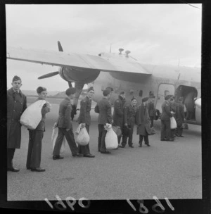 View of unidentified Air Training Corps Cadets in uniform boarding a transport plane at Rongotai Airport for Woodbourne RNZAF Base, Wellington City