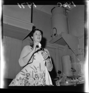 Mrs Walmsley holding an egg at a cooking demonstration