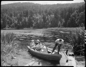 Group in row boat, Lake Matheson, West Coast region - Photograph taken by J Rundle