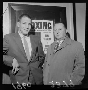 Portrait of boxer Clive Stewart and his unidentified manager within an unknown building location, probably Wellington City
